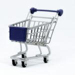 Miniature shopping cart on white background